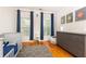 Well-lit Bedroom with hardwood floors, gray dresser and curtains, and a gray and white geometric rug at 2610 Oglethorpe Ne Cir, Brookhaven, GA 30319