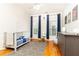 Bright Bedroom with hardwood floors, a gray geometric rug, and neutral walls with blue curtains at 2610 Oglethorpe Ne Cir, Brookhaven, GA 30319