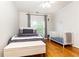 Cozy bedroom with a queen-size bed, crib, hardwood floors, and ample natural light at 2610 Oglethorpe Ne Cir, Brookhaven, GA 30319