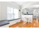 Charming dining area with bench seating, hardwood floors, and an arched opening leading to the kitchen at 2610 Oglethorpe Ne Cir, Brookhaven, GA 30319