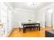 Bright dining room featuring hardwood floors, a modern table with bench, and access to outdoor area at 2610 Oglethorpe Ne Cir, Brookhaven, GA 30319