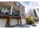 Brick townhome with second-story patios provides garage parking for guests and residents at 2610 Oglethorpe Ne Cir, Brookhaven, GA 30319