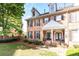 Attractive brick townhouse with black shutters, a covered entry, and manicured lawn at 2610 Oglethorpe Ne Cir, Brookhaven, GA 30319