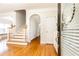 Bright foyer with hardwood floors, staircase, and arched doorway offering a great view into other rooms at 2610 Oglethorpe Ne Cir, Brookhaven, GA 30319