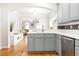 Updated kitchen with gray cabinets, stainless steel appliances, and an open view to the living area at 2610 Oglethorpe Ne Cir, Brookhaven, GA 30319