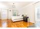 Spacious main bedroom with hardwood floors, large windows, crown molding, and a modern chandelier at 2610 Oglethorpe Ne Cir, Brookhaven, GA 30319