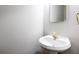 Well-lit powder room featuring a pedestal sink, decorative faucet, and clean, modern design at 2610 Oglethorpe Ne Cir, Brookhaven, GA 30319