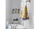 Bathroom featuring a round sink, mirror, white walls, and a towel rack with yellow striped towels at 2716 Georgia 16, Carrollton, GA 30116