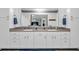 Bright bathroom featuring double sinks, white cabinets, and blue mat at 2716 Georgia 16, Carrollton, GA 30116