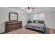 Comfortable bedroom features a ceiling fan, a dresser, and a window letting in ample natural light at 2716 Georgia 16, Carrollton, GA 30116