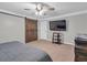 Cozy bedroom with TV, ceiling fan, and wooden sliding barn door for added privacy at 2716 Georgia 16, Carrollton, GA 30116