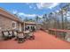 Expansive red-stained deck perfect for outdoor entertaining with ample seating and serene backyard views at 2716 Georgia 16, Carrollton, GA 30116