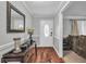 Welcoming foyer with hardwood floors, decorative table, and a front door with ornate glass detailing at 2716 Georgia 16, Carrollton, GA 30116