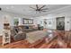 Spacious living room featuring a stone fireplace, hardwood floors, and a comfortable seating area with a ceiling fan at 2716 Georgia 16, Carrollton, GA 30116