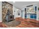 Inviting space with a stone accent wall, a cozy wood-burning stove, and a stylish bar area at 2716 Georgia 16, Carrollton, GA 30116