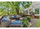 Large backyard with a back deck, patio seating, a fire pit, and lush landscaping at 2936 Summitop Ne Rd, Marietta, GA 30066