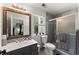 Bathroom featuring a vanity, toilet, and tiled shower with glass door and a window bringing in natural light at 2936 Summitop Ne Rd, Marietta, GA 30066