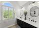 Bright bathroom with dual sinks, sleek black cabinets, and modern mirrors at 2936 Summitop Ne Rd, Marietta, GA 30066