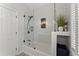 Tiled shower with a glass door and built-in shower caddy at 2936 Summitop Ne Rd, Marietta, GA 30066