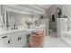 Bright primary bathroom featuring dual sinks, vanity, a chair, and tub at 2936 Summitop Ne Rd, Marietta, GA 30066