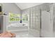 Bright primary bathroom with a soaking tub, glass block window, and separate shower at 2936 Summitop Ne Rd, Marietta, GA 30066