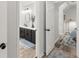 Bathroom view featuring a dual-doorway and modern black bathroom vanity at 2936 Summitop Ne Rd, Marietta, GA 30066