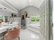 Bright primary bathroom featuring dual sinks, vanity, soaking tub, and a glass block window at 2936 Summitop Ne Rd, Marietta, GA 30066