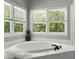 Bright bathroom featuring a tub beneath windows offering wooded views at 2936 Summitop Ne Rd, Marietta, GA 30066