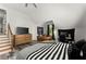 Bright bedroom featuring a cozy seating area, large dresser, and stylish black and white striped bedding at 2936 Summitop Ne Rd, Marietta, GA 30066