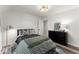 Well-lit bedroom featuring carpet floors, a comfortable bed, and a dresser at 2936 Summitop Ne Rd, Marietta, GA 30066