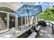 Beautiful deck with dining area and grill, offering stunning views of the lush backyard and pool at 2936 Summitop Ne Rd, Marietta, GA 30066