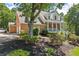 Charming two-story brick home with a welcoming front porch and lush, mature landscaping at 2936 Summitop Ne Rd, Marietta, GA 30066