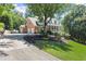 Brick home with three-car garage, long driveway, manicured lawn, and a welcoming front porch at 2936 Summitop Ne Rd, Marietta, GA 30066