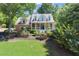 Inviting brick home with a covered front porch, set amidst a lush green lawn and mature trees at 2936 Summitop Ne Rd, Marietta, GA 30066
