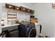 Functional laundry room with washer, dryer, storage, and shelving at 2936 Summitop Ne Rd, Marietta, GA 30066