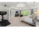 Well-lit primary bedroom featuring tray ceiling, Peloton, and a large window at 2936 Summitop Ne Rd, Marietta, GA 30066