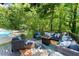 Cozy outdoor seating area with comfortable furniture, a fire pit, and a view of the refreshing pool at 2936 Summitop Ne Rd, Marietta, GA 30066