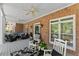Relaxing covered porch featuring comfortable seating, ceiling fans, and classic brick columns at 2936 Summitop Ne Rd, Marietta, GA 30066