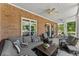 Inviting covered porch with cozy seating, ceiling fans, and views of the beautifully landscaped yard at 2936 Summitop Ne Rd, Marietta, GA 30066