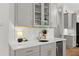Elegant wet bar features quartz countertops, undermount lighting and gray cabinetry at 2936 Summitop Ne Rd, Marietta, GA 30066