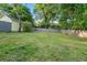 Large, grassy backyard surrounded by a wooden fence and mature trees at 378 Grant Park Pl, Atlanta, GA 30315