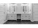Bathroom featuring double vanity, white cabinets, black hardware, herringbone flooring, and modern lighting at 378 Grant Park Pl, Atlanta, GA 30315