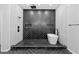 Modern bathroom with a soaking tub and luxurious shower including black herringbone tile wall design at 378 Grant Park Pl, Atlanta, GA 30315