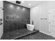 Modern bathroom features a luxurious shower and soaking tub with beautiful herringbone tile design at 378 Grant Park Pl, Atlanta, GA 30315