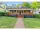 Charming home featuring a covered porch with wooden details and a brick pathway leading to the entrance at 378 Grant Park Pl, Atlanta, GA 30315
