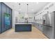 Modern kitchen featuring a central island, gray cabinetry, marble countertops, and stainless steel appliances at 378 Grant Park Pl, Atlanta, GA 30315