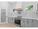 Bright kitchen features gray cabinets, stainless steel appliances, and a pantry at 378 Grant Park Pl, Atlanta, GA 30315