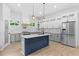 Modern kitchen featuring a central island, gray cabinetry, marble countertops, and stainless steel appliances at 378 Grant Park Pl, Atlanta, GA 30315