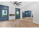 Spacious living room featuring an electric fireplace, wood floors and stylish paneling at 378 Grant Park Pl, Atlanta, GA 30315