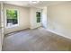 Bedroom with neutral carpet and paint and two well-lit windows at 6370 Maid Marion Close, Alpharetta, GA 30005